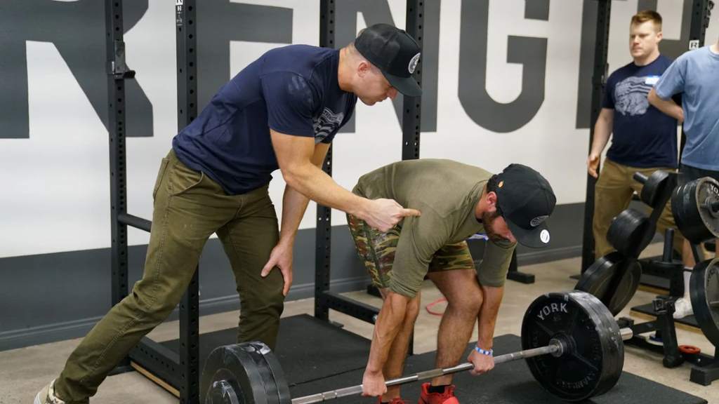 Lifter applying chalk to hands before deadlift to prevent grip slip.