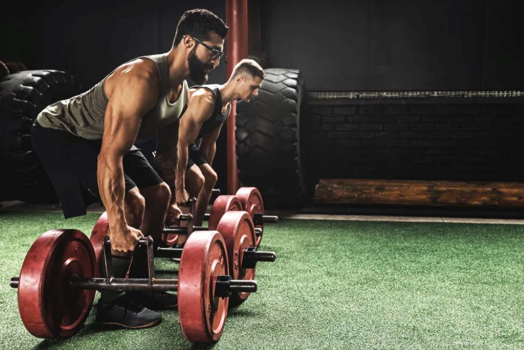 Athlete performing farmer walks to build forearm strength for better deadlift hold.